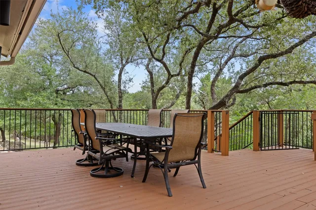 a view of a roof deck with table and chairs and wooden floor