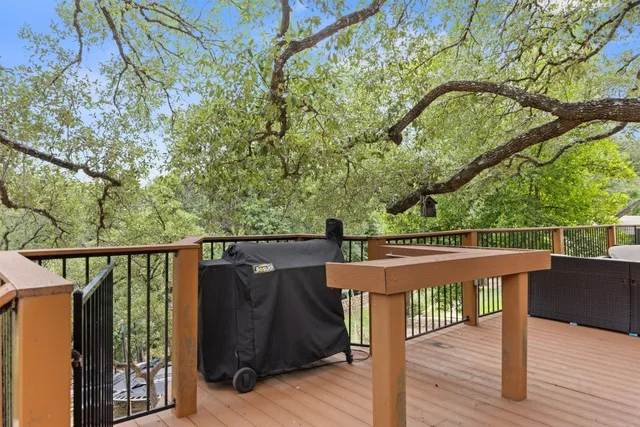 a view of a deck with wooden floor and outdoor seating