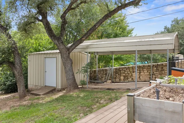 a view of a backyard with a large tree