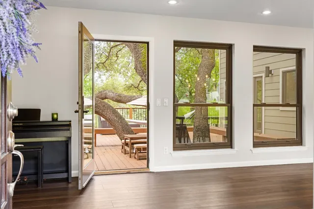 a view of a living room with hardwood floor and a window