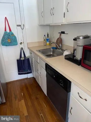 a kitchen with a sink and cabinets