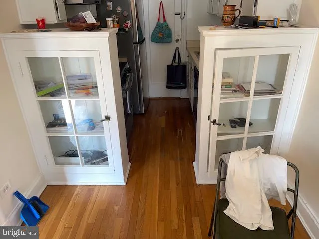 a view of hallway with wooden floor and closet