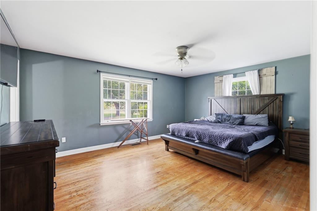 570 Wildcat Bridge Road Royston, GA 30662 - Photo 14 of 29 a spacious bedroom with a bed and wooden floor