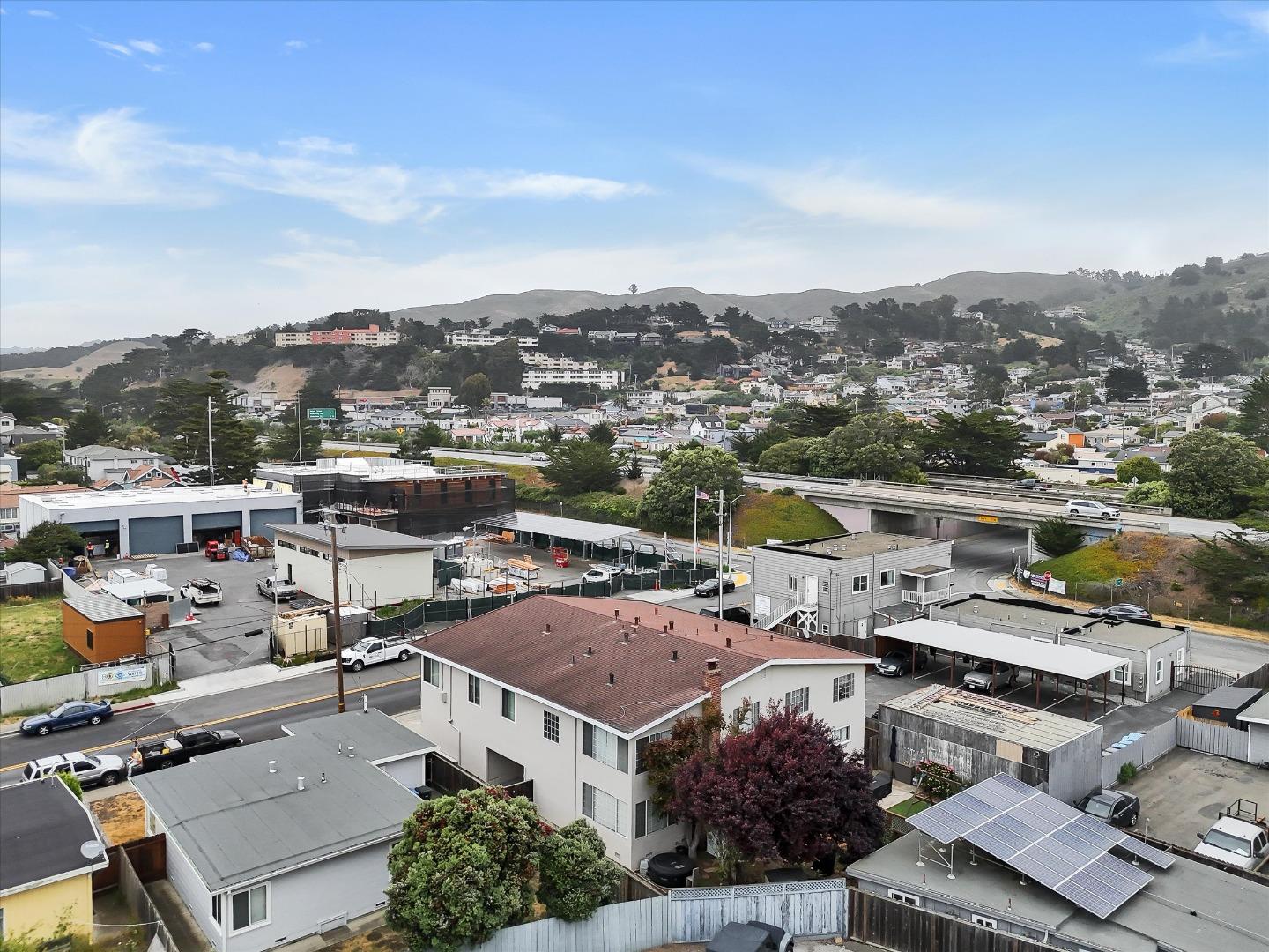 160 Clarendon Road Pacifica, CA 94044 - Photo 41 of 81 an aerial view of a house with a lot of residential buildings ocean and mountain view in back