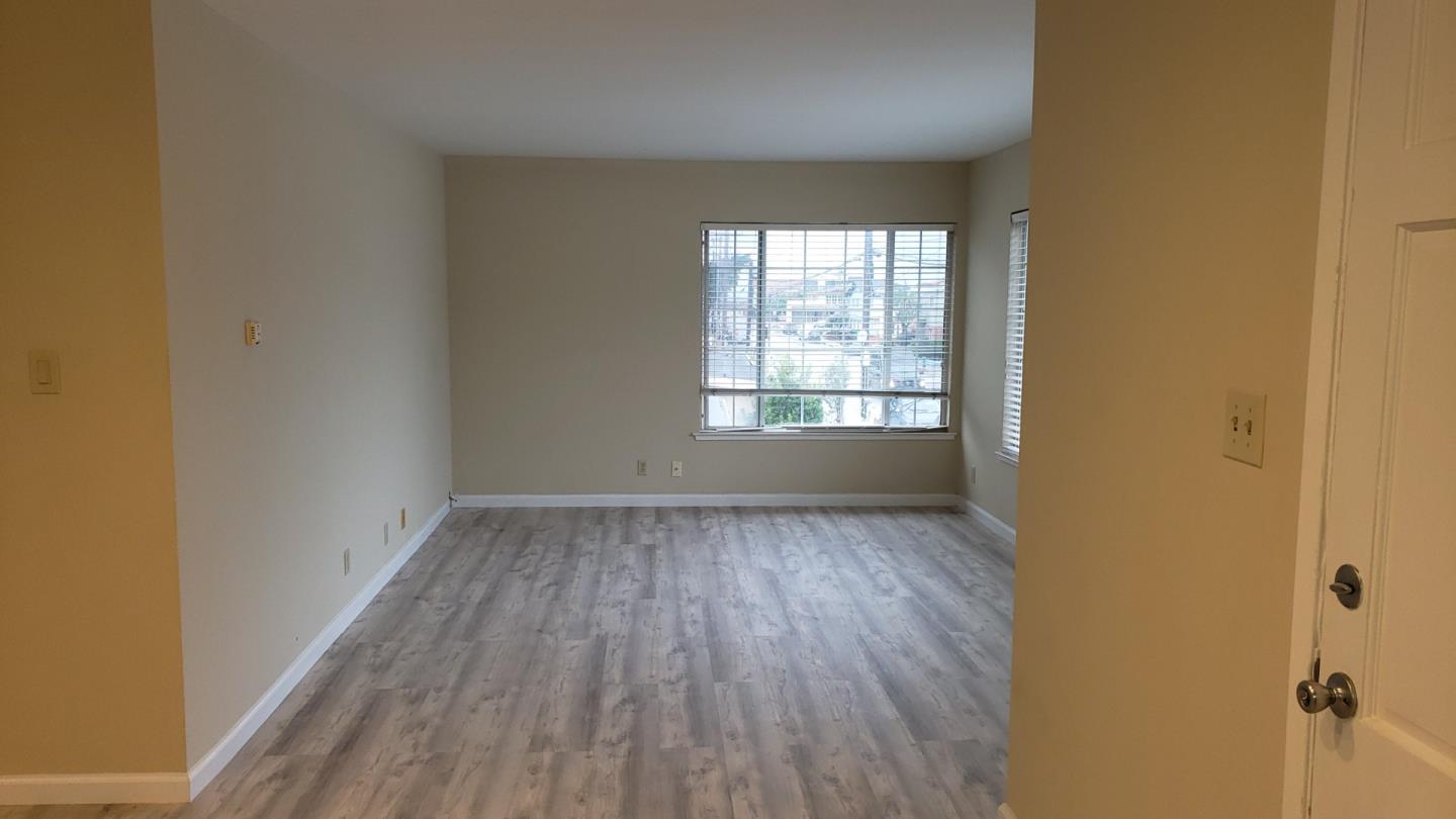 160 Clarendon Road Pacifica, CA 94044 - Photo 65 of 81 an empty room with wooden floor and windows