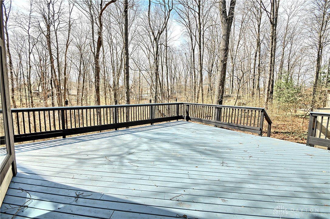 8711 Nicole Lane Springboro, OH 45066 - Photo 77 of 87 This spacious deck offers a tranquil retreat with serene views of surrounding trees.