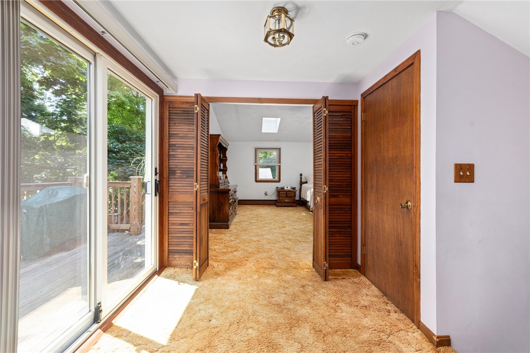 1 Simmons Road Barrington, RI 02806 - Photo 6 of 24 Sunny hallway to primary bedroom: sliders to deck, storage closet and access to semi private entrance!