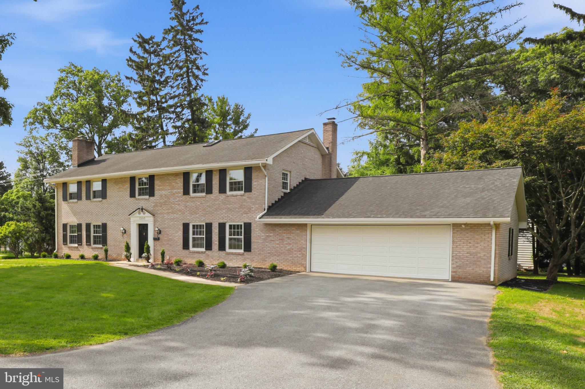 1300 Newton Road Lancaster, PA 17603 - Photo 3 of 68 Charming brick home with lush greenery.