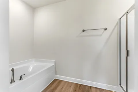 a bathroom with a tub and shower