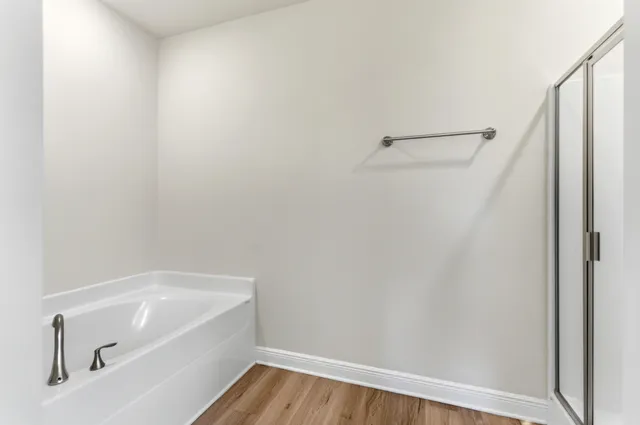 a bathroom with a tub and shower