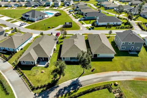 an aerial view of a house with a swimming pool