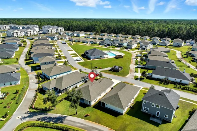 an aerial view of residential houses with outdoor space