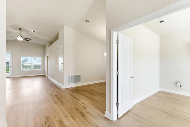 a view of a hallway with wooden floor