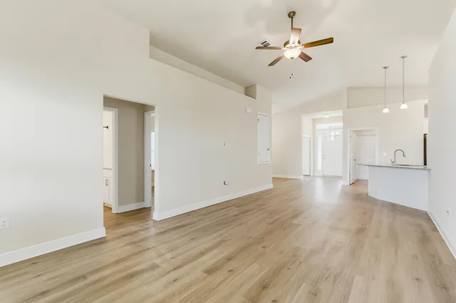 a view of an empty room with a kitchen