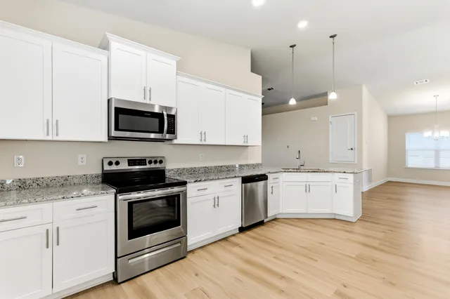 a kitchen with a stove a sink and a microwave