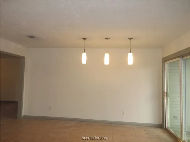 a view of a room with lots of racks on the wall and shower