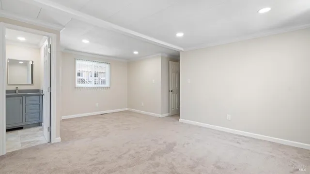 an empty room with a empty space and windows