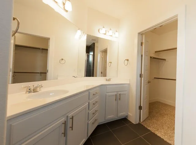a bathroom with a shower and a glass door