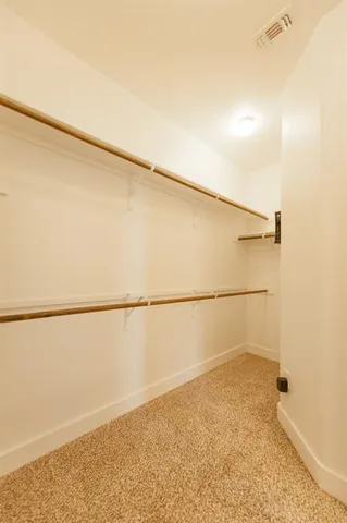 a view of a house with large windows and a large tree