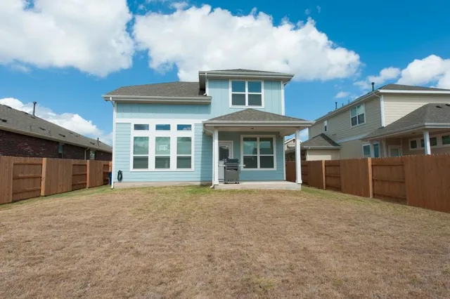 a room with pool table and windows