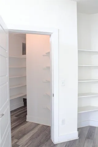a view of a room with wooden floor