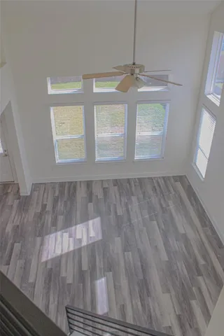 a view of an empty room with wooden floor