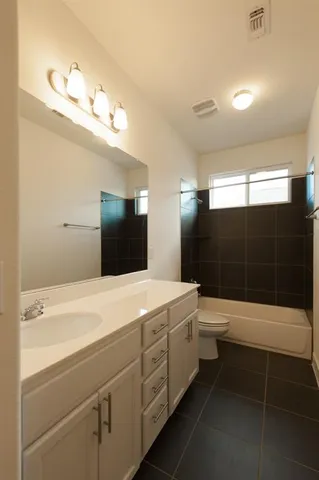 a spacious bathroom with a shower sink and mirror