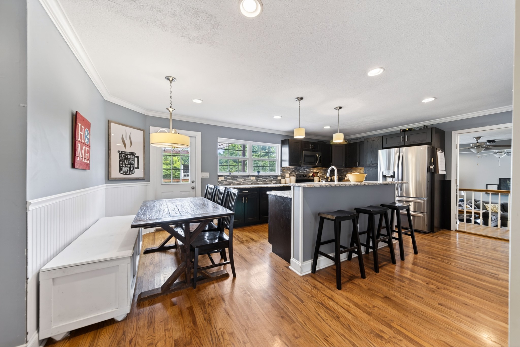 8023 Bethlehem Road Springfield, TN 37172 - Photo 29 of 55 a kitchen with stainless steel appliances a dining table chairs stove a refrigerator and cabinets