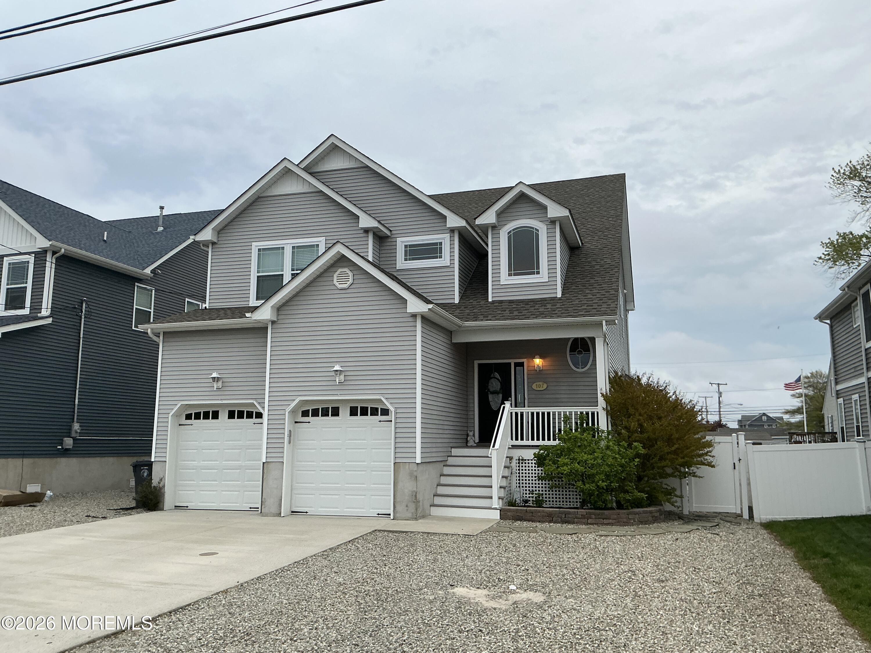 107 Waldron Road Toms River, NJ 08753 - Photo 1 of 20 a front view of a house with a yard and garage