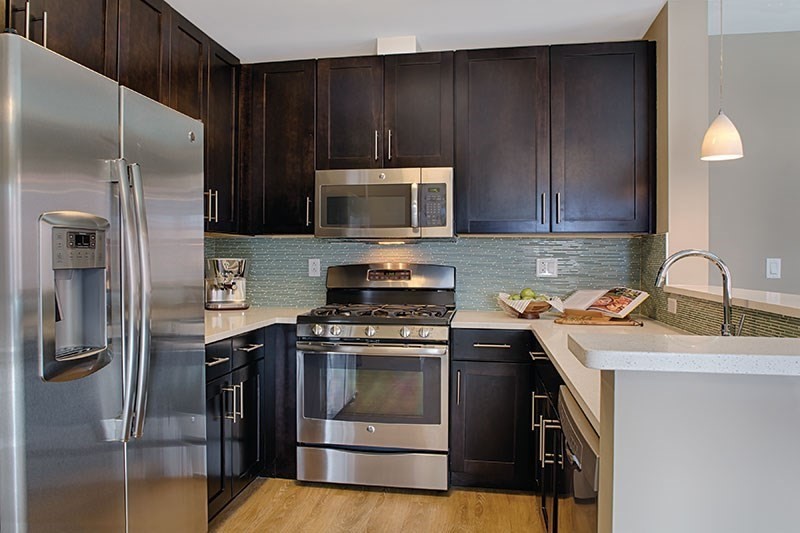 33 Rogers Street, Unit 601 Cambridge, MA 02142 - Photo 3 of 11 a kitchen with a stove microwave and refrigerator