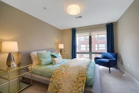 a bedroom with a bed and a window