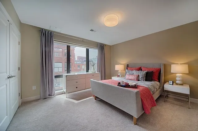 a bed room with a bed and a large window