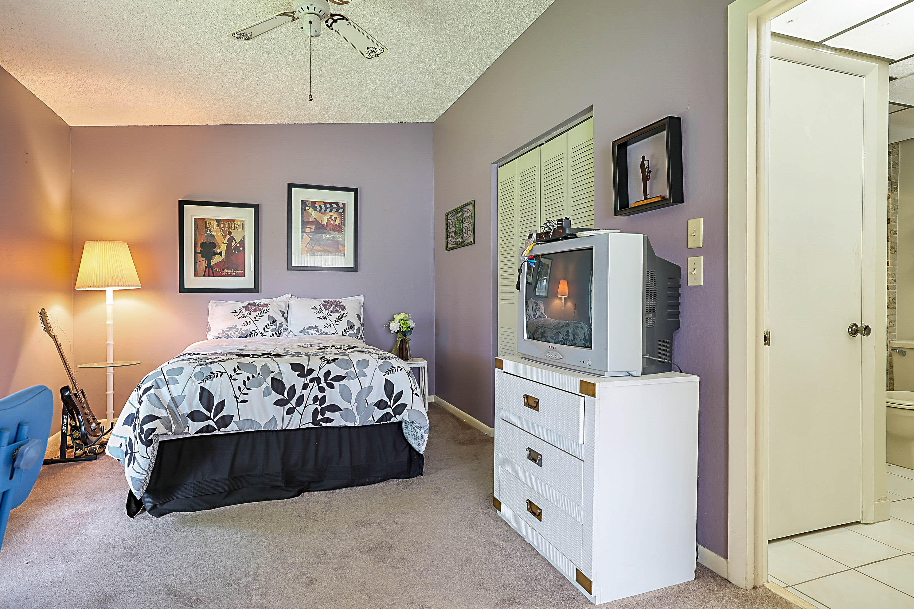 5231 Copperleaf Circle Delray Beach, FL 33484 - Photo 21 of 31 a bedroom with a bed window and a flat screen tv