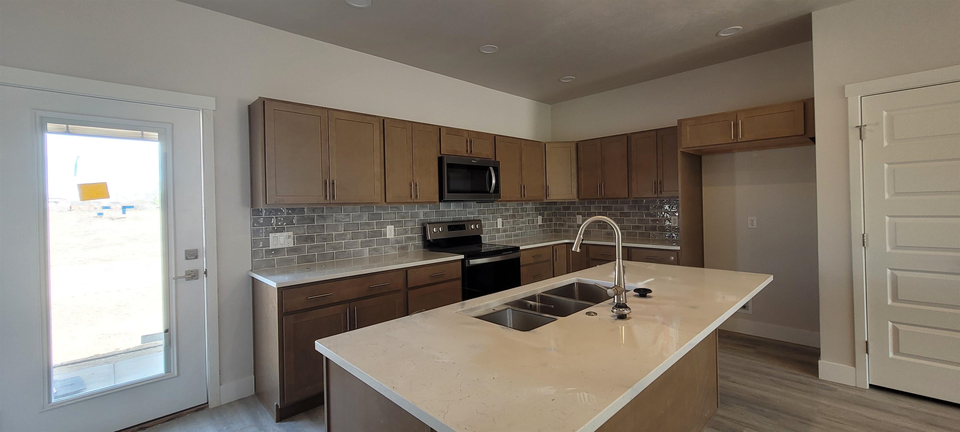 2460 Ross Road Grand Junction, CO 81505 - Photo 3 of 9 a kitchen with a sink a stove a refrigerator and a microwave