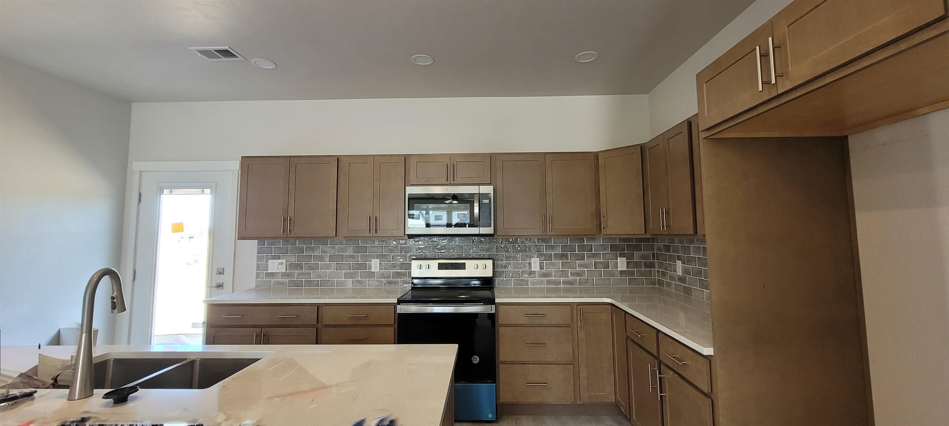 2460 Ross Road Grand Junction, CO 81505 - Photo 4 of 9 a kitchen with stainless steel appliances granite countertop a sink stove and cabinets