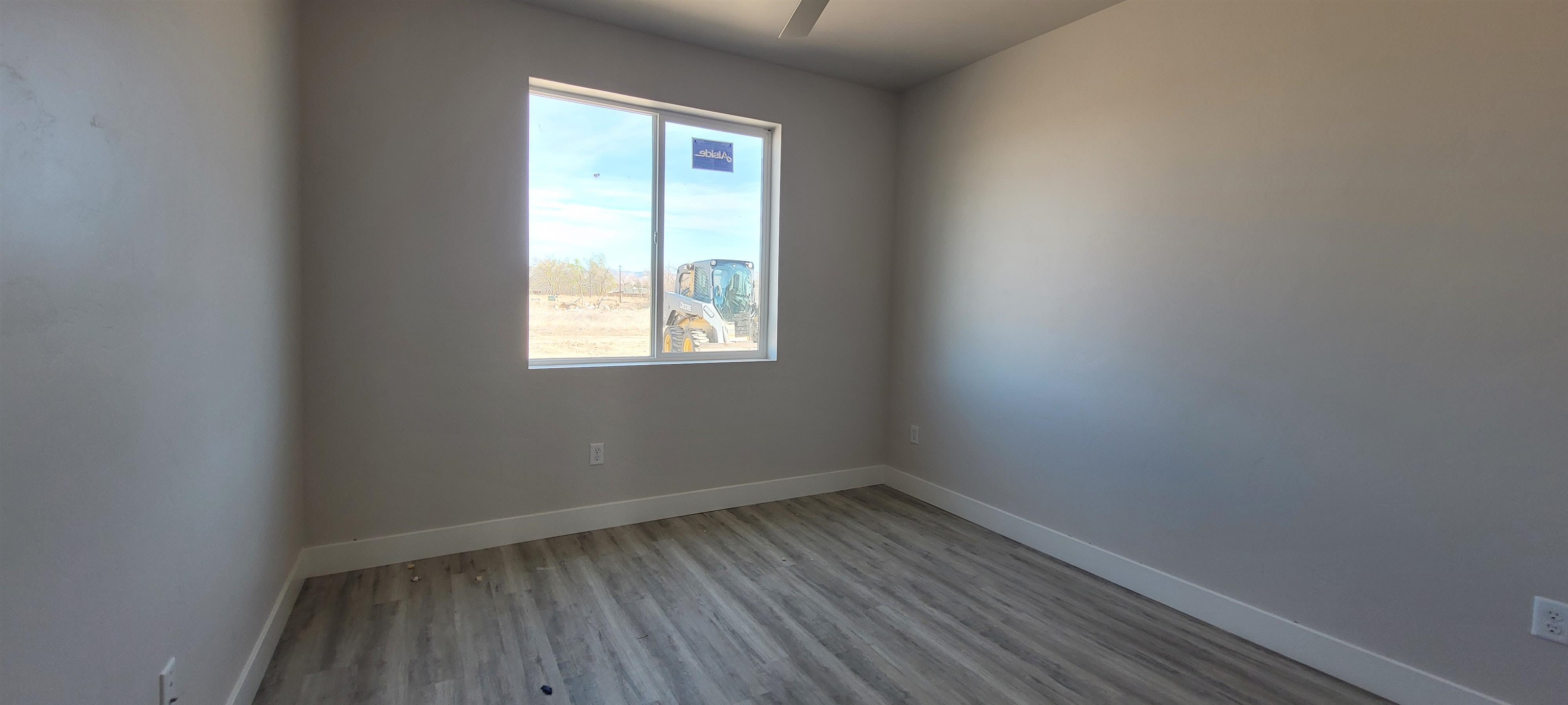 2460 Ross Road Grand Junction, CO 81505 - Photo 5 of 9 a view of a room that has wooden floor and window