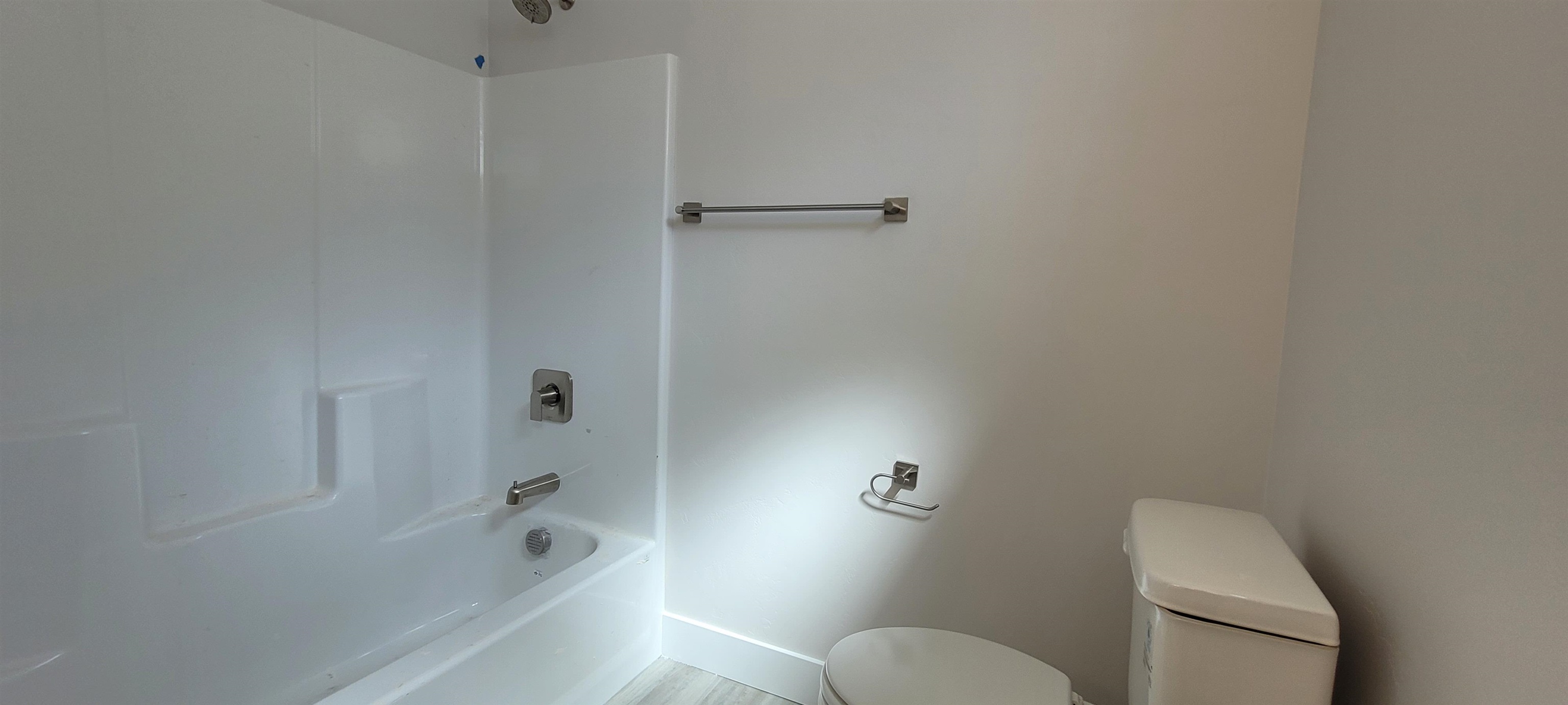 2460 Ross Road Grand Junction, CO 81505 - Photo 7 of 9 a bathroom with a granite countertop toilet and a bathtub