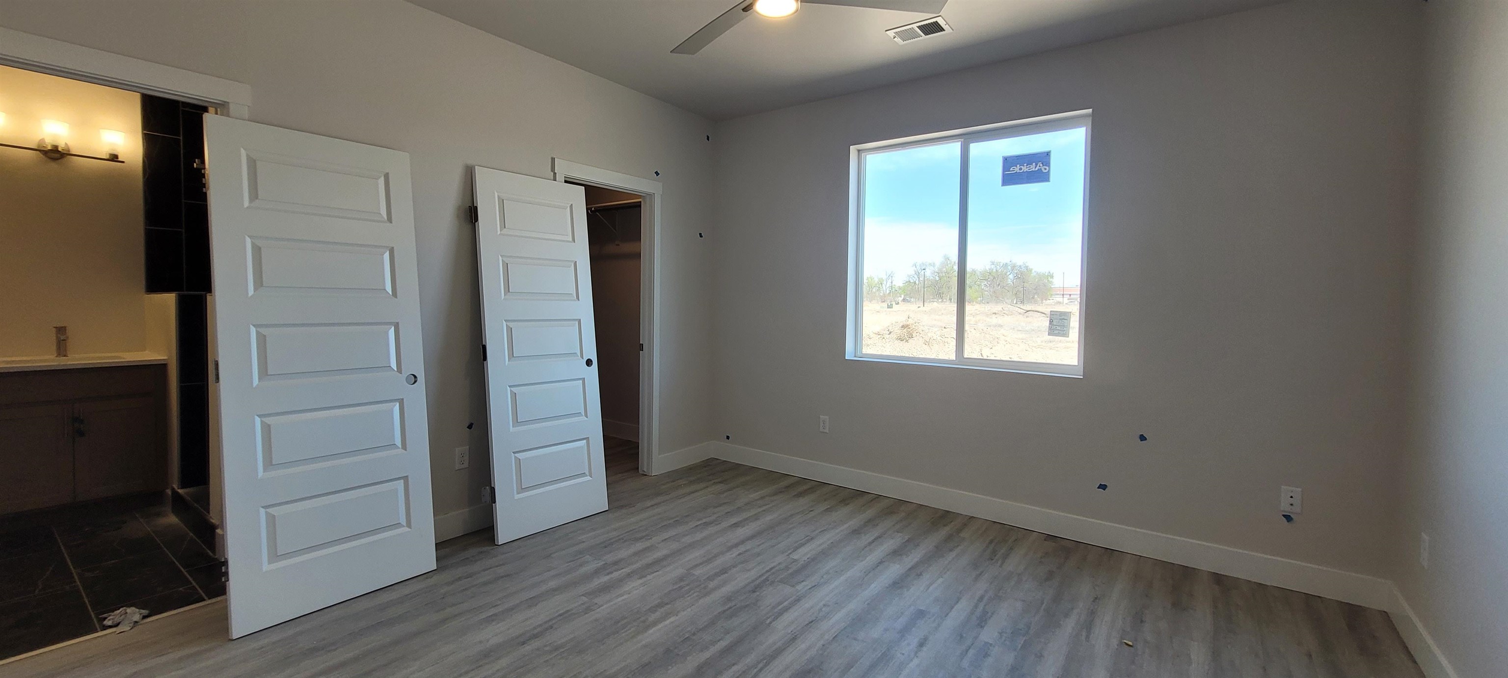 2460 Ross Road Grand Junction, CO 81505 - Photo 8 of 9 an empty room with wooden floor closet and windows