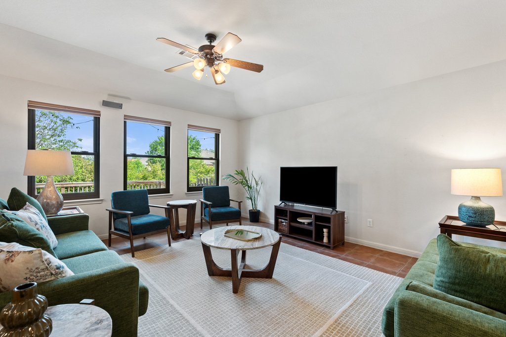 11508 Gossamer Drive Austin, TX 78754 - Photo 7 of 40 Living area featuring large windows, a ceiling fan, and neutral colors throughout