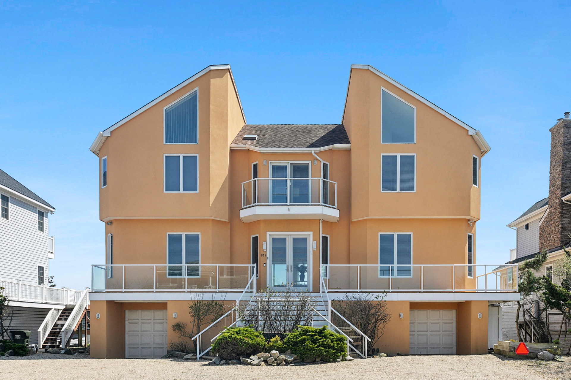 a front view of a residential apartment building with a yard
