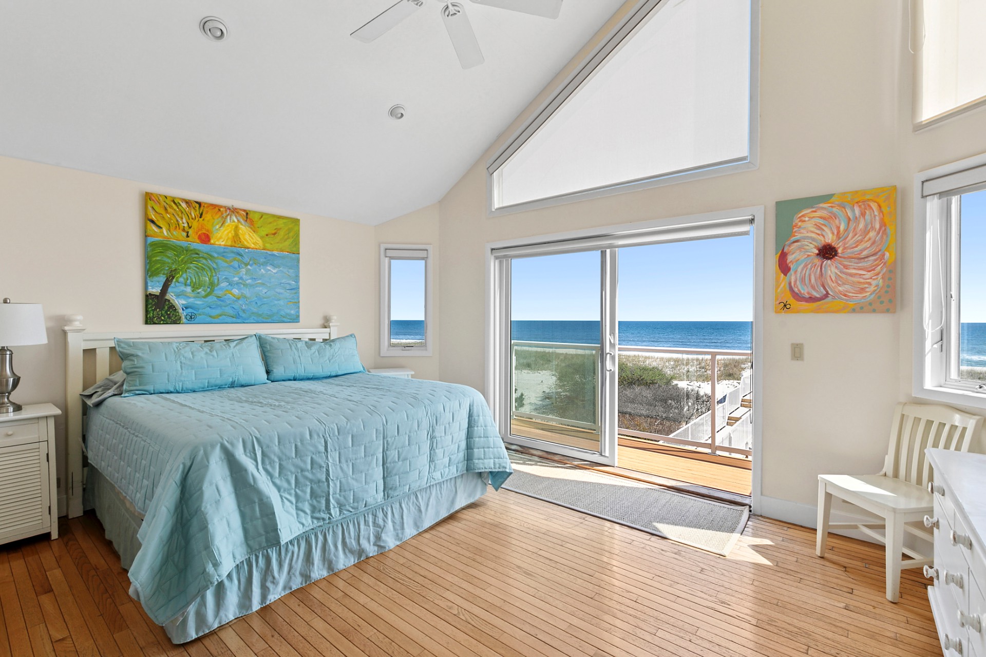 819 Dune Road Westhampton Beach, NY 11978 - Photo 11 of 18 a spacious bedroom with a balcony a bed and a large window