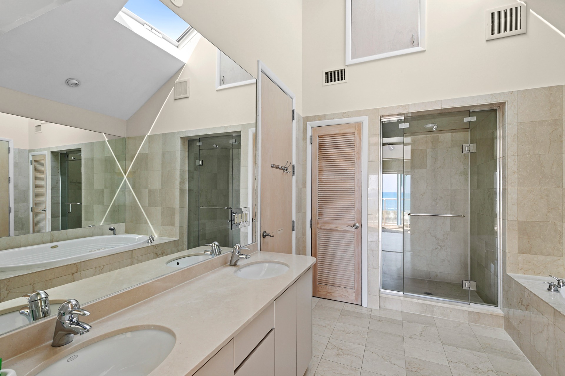 819 Dune Road Westhampton Beach, NY 11978 - Photo 14 of 18 a bathroom with a double vanity sink mirror and shower