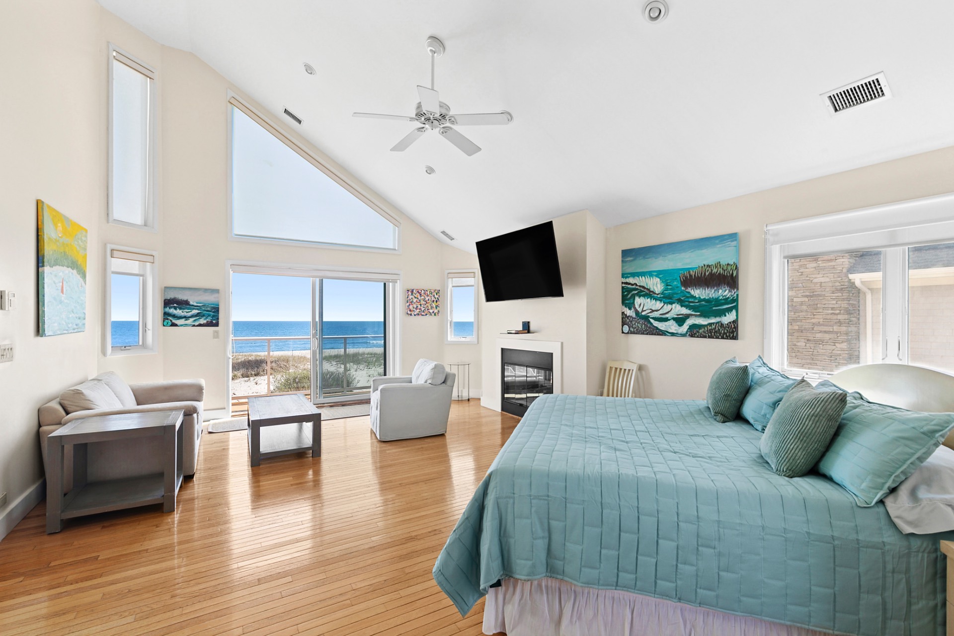 819 Dune Road Westhampton Beach, NY 11978 - Photo 17 of 18 a bedroom with a balcony a bed and a flat screen tv