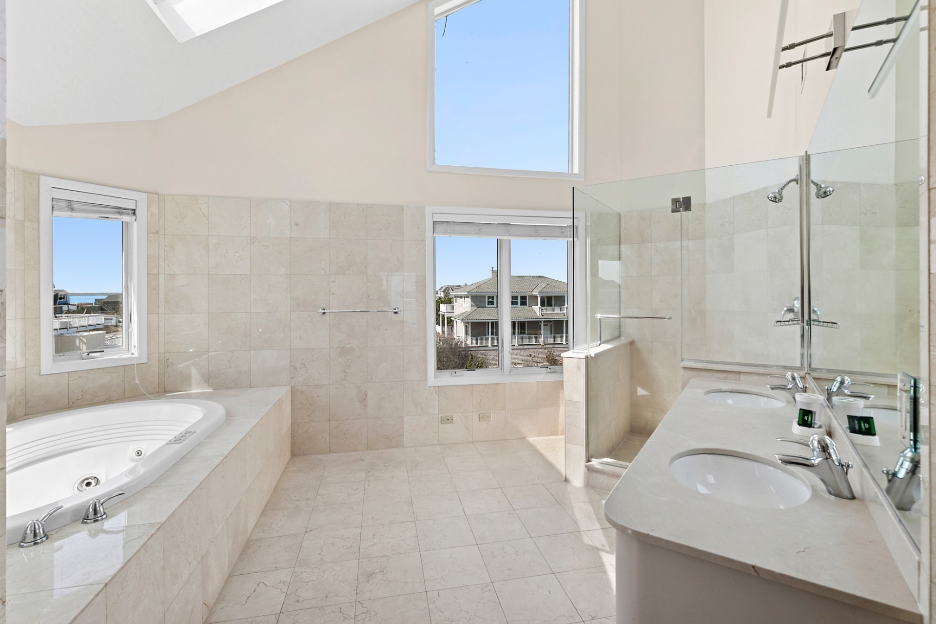 819 Dune Road Westhampton Beach, NY 11978 - Photo 18 of 18 a bathroom with a tub sink and mirror