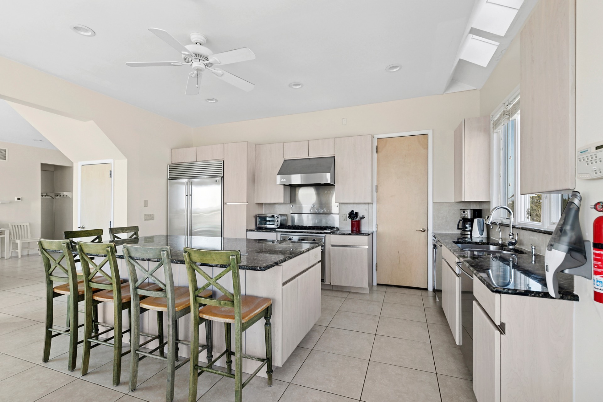 819 Dune Road Westhampton Beach, NY 11978 - Photo 4 of 18 a kitchen with a table chairs stove and cabinets