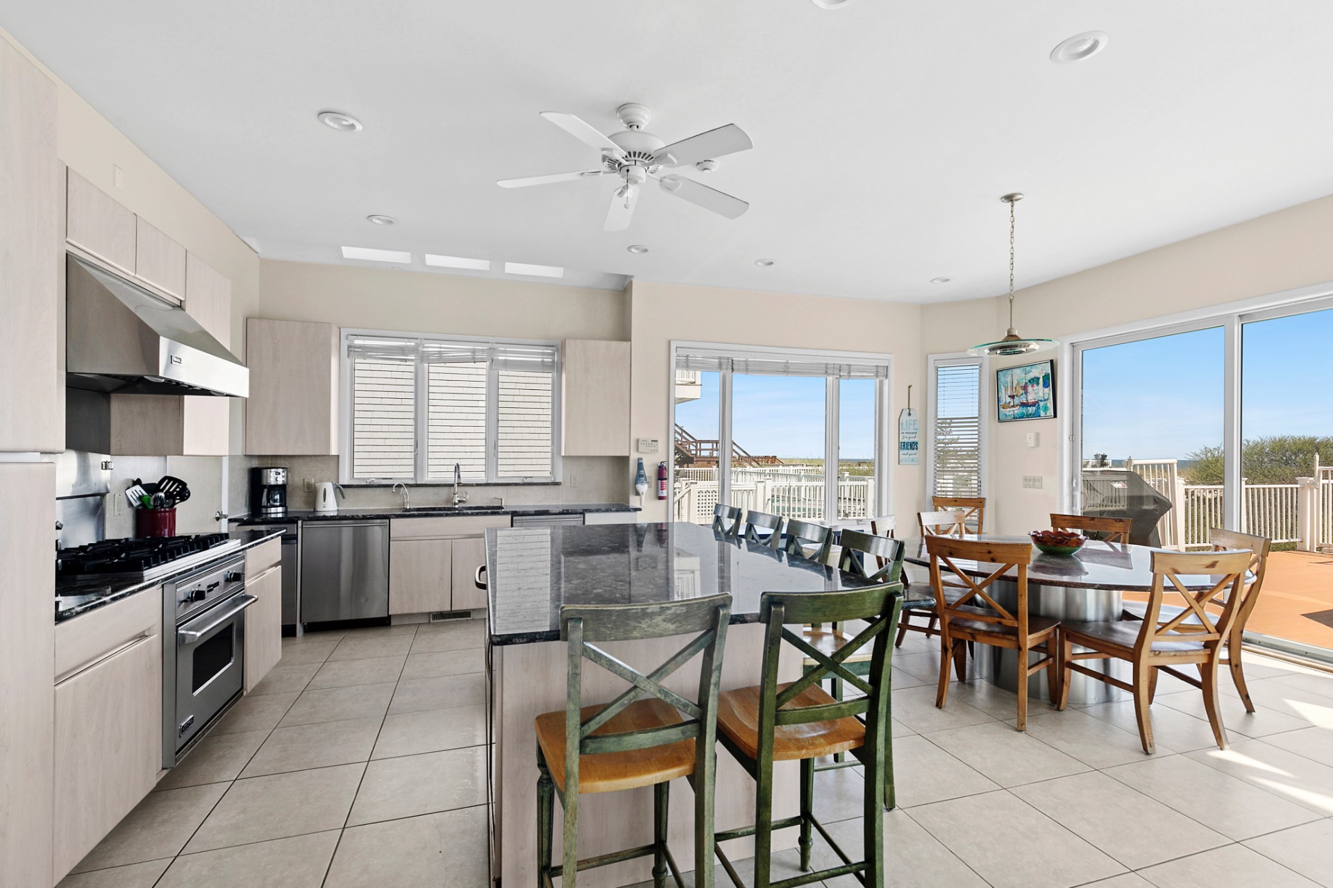 819 Dune Road Westhampton Beach, NY 11978 - Photo 5 of 18 a kitchen with a table chairs stove and cabinets