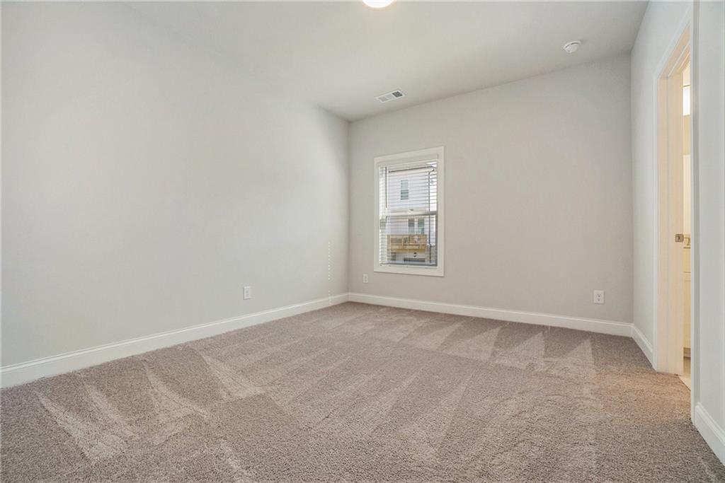 106 Basil Street Cumming, GA 30040 - Photo 19 of 25 an empty room with windows