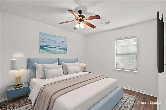 a bedroom with a large bed and a window