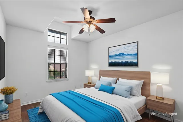 a bedroom with bed and wooden floor