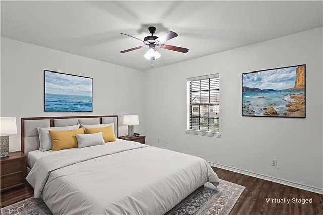 a bedroom with a large bed and a chandelier